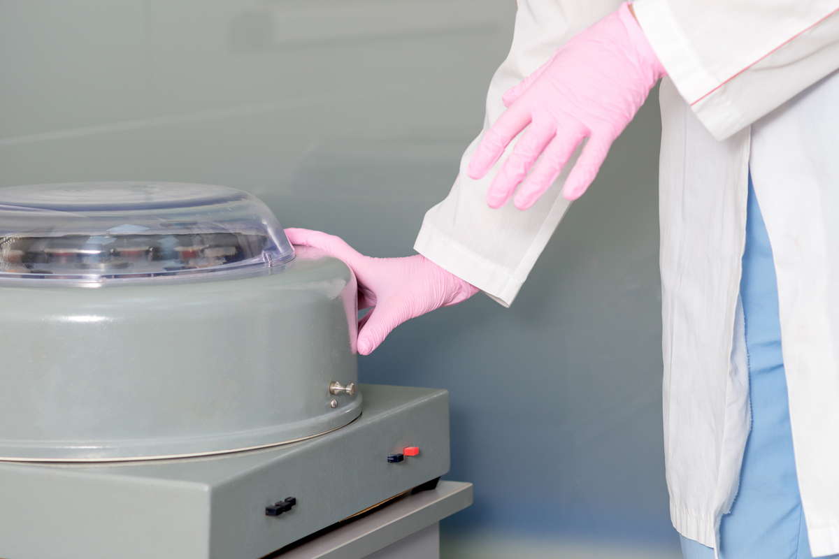 nurse using centrifuge machine