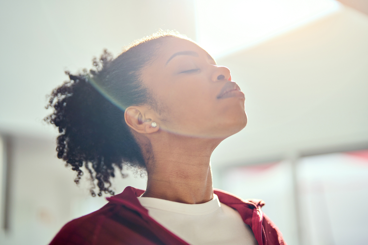young woman taking a breath in the sunlight