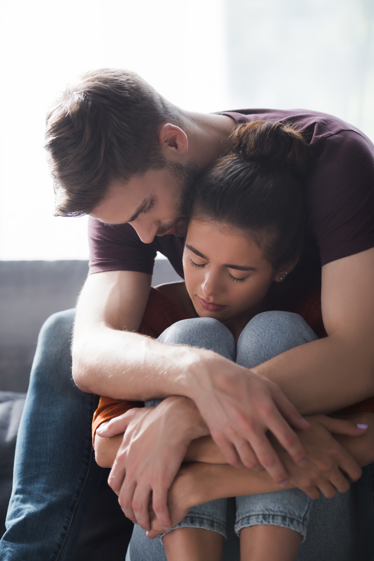 young man and woman embracing while sitting